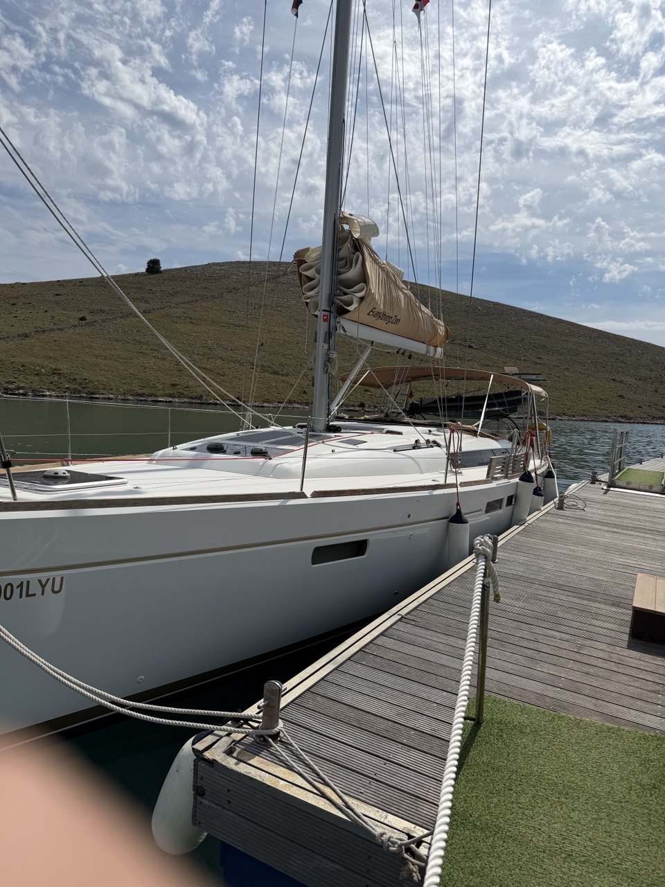 Everything Zen tied alongside a pontoon with hillside behind