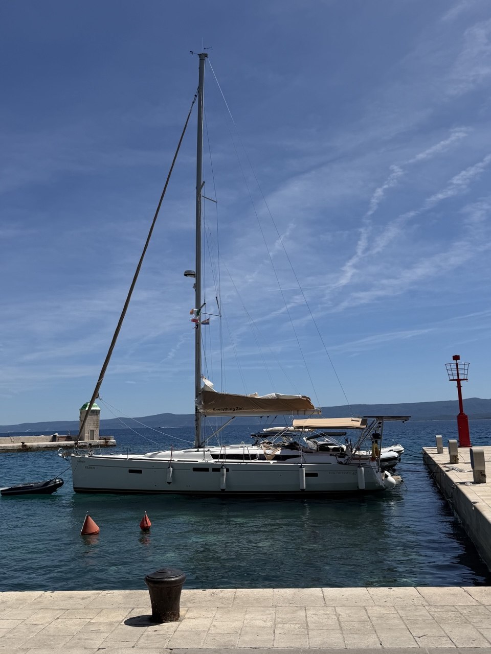 Everything Zen moored in blue water with the full rig visible